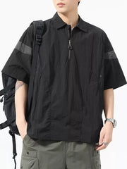 Black quarter-zip polo shirt with short sleeves, contrasting arm bands, and a chest pocket.