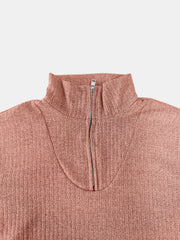 Ribbed knit quarter-zip pullover in burnt coral with a mock neck and silver zipper detail.