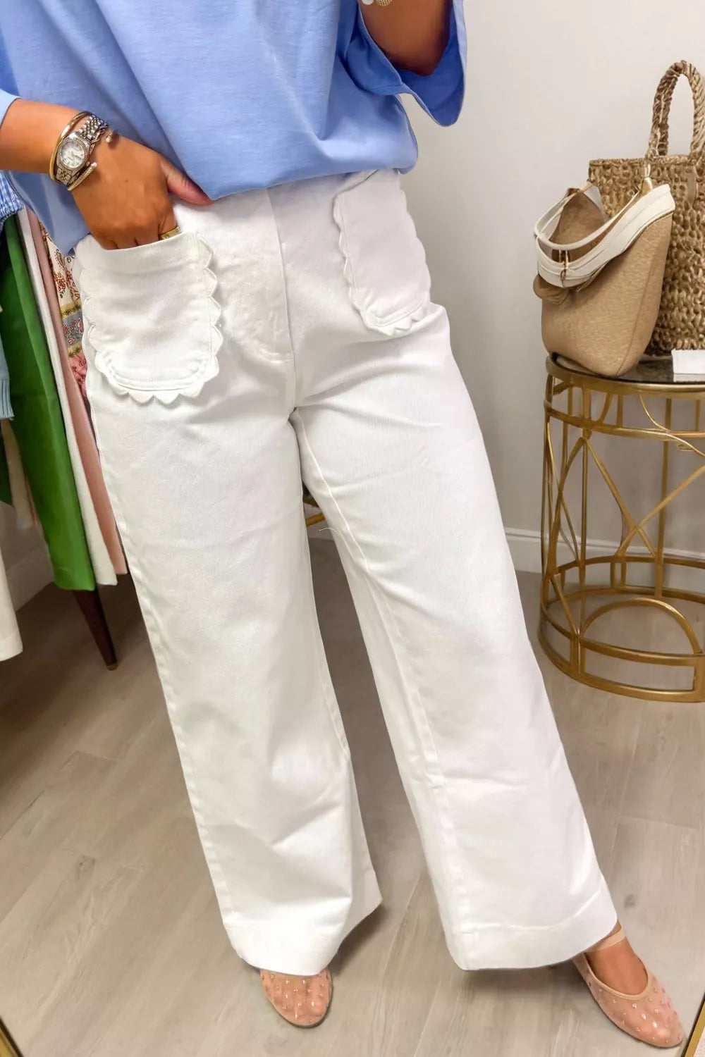 White denim wide-leg jeans with scalloped pocket details.