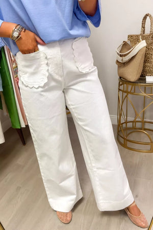 White denim wide-leg jeans with scalloped pocket details.