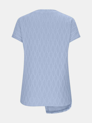 Light blue textured tee with asymmetric hem and short sleeves.