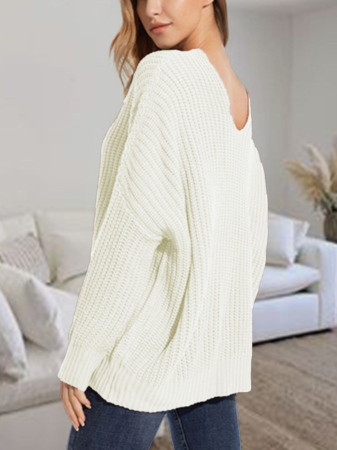 Relaxed fit ivory ribbed knit sweater with batwing sleeves and a deep V-neckline.