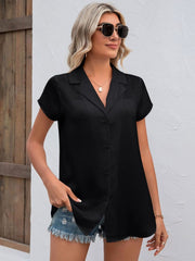 Black textured collared short sleeve shirt with button front and back pleat detail.