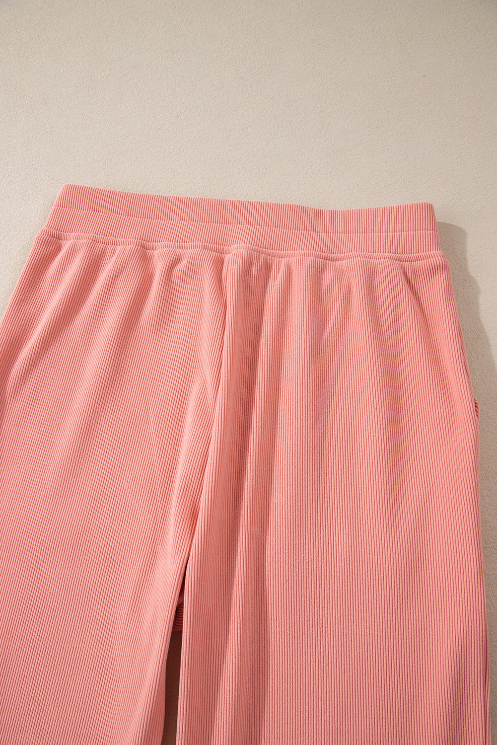 Pink corduroy lounge pants with relaxed fit and elastic waistband