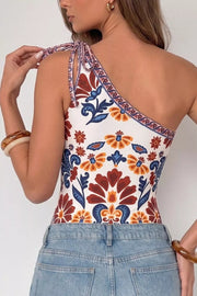 Vibrant floral one-shoulder bodysuit with tie straps and cutout detail.