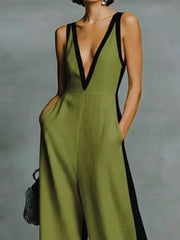 Olive wide-leg jumpsuit with deep V-neck and black contrast trim.