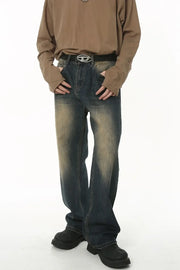 Faded wash baggy denim jeans in medium blue with a relaxed fit and distressed details.