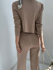 Taupe ribbed knit ensemble with gold button detail on sleeve and scarf accent.