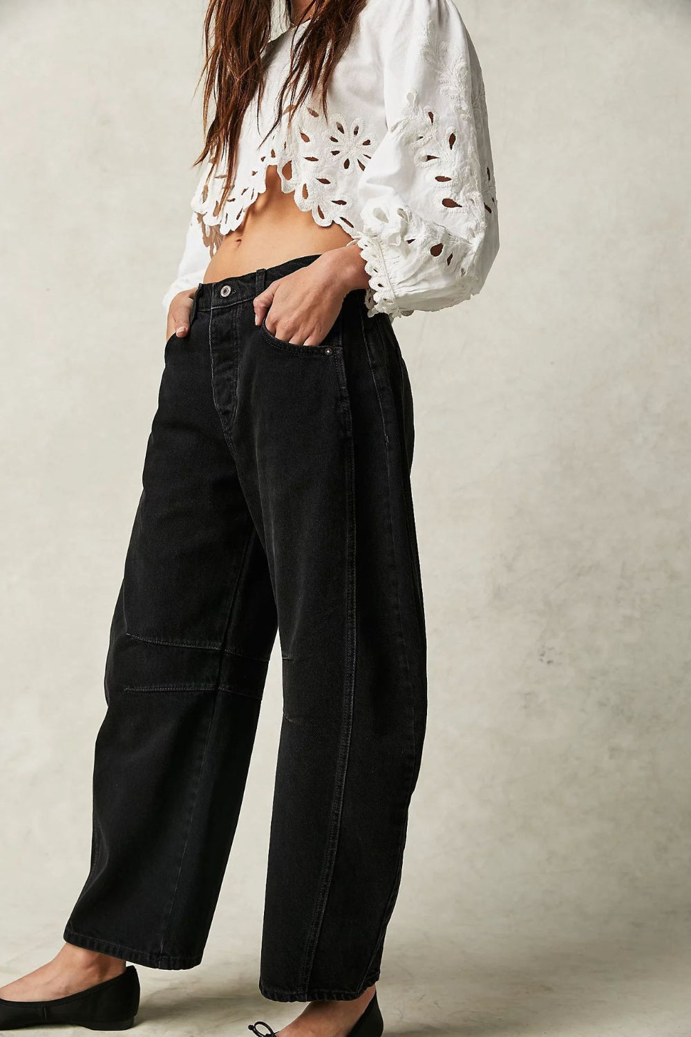 Black denim barrel leg jeans with button fly and pocket detail