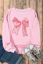 Blush pink crewneck sweatshirt with a pink leopard print bow graphic.