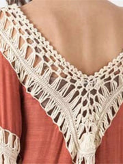 Orange long sleeve cardigan with crochet trim and fringe detail