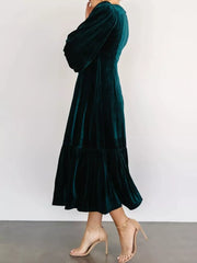Opulent velvet midi dress in peacock blue with tiered skirt and balloon sleeves.