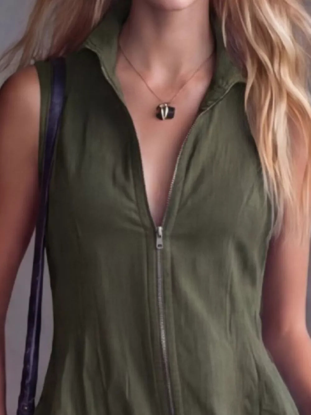 Army green sleeveless dress with a front zipper and collared neckline.