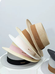 Straw boater hats in beige, blush pink, gray, and black with ribbon details.