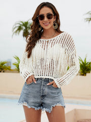 Cream open-knit crop sweater with fringe detail and long sleeves.