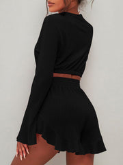 Black ribbed crop set with flared sleeves and ruffled hem shorts.