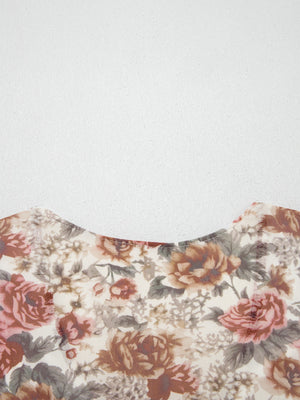 Charming floral mesh blouse with a round neckline and ruffled detail.