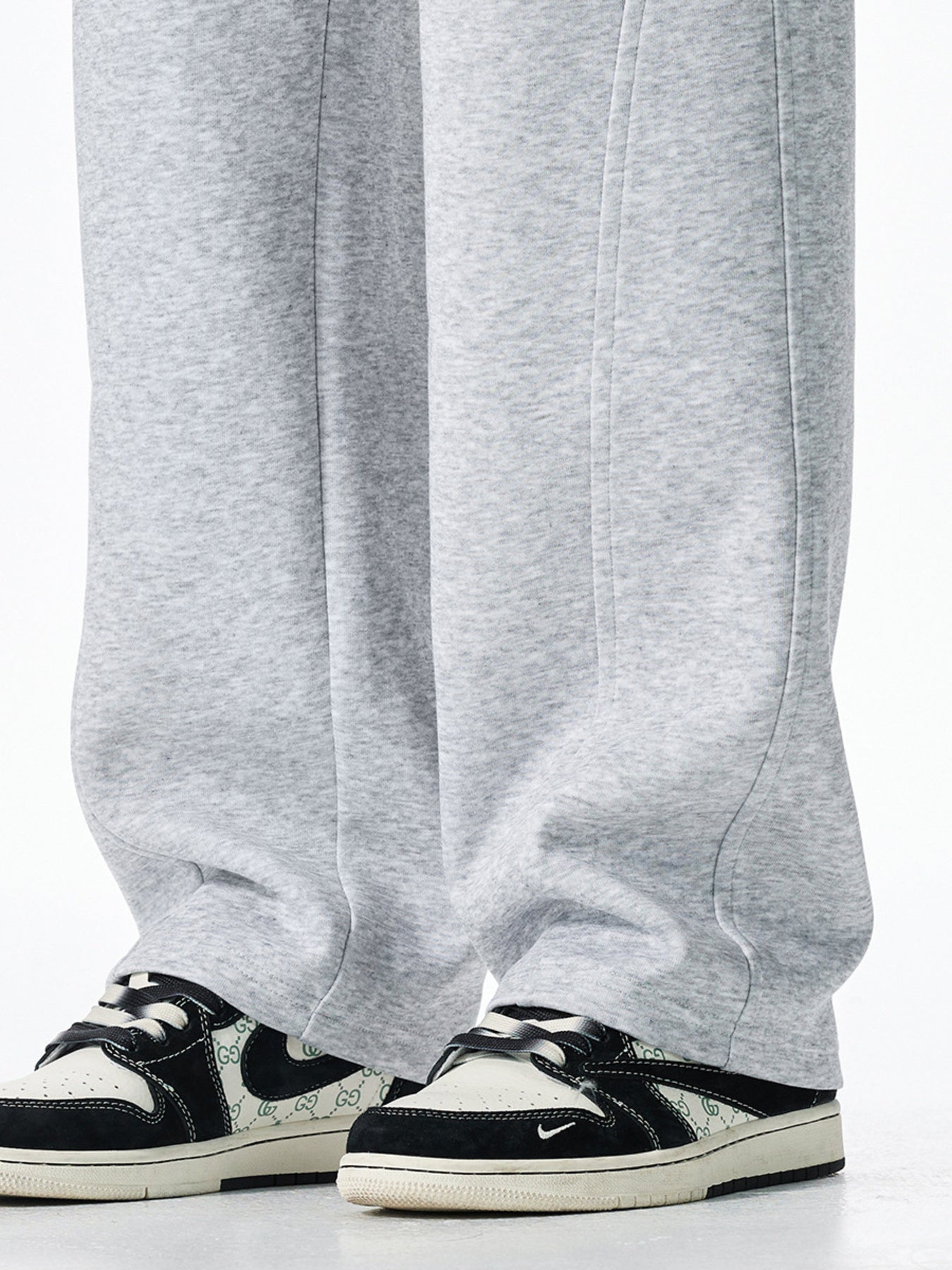 Men's grey casual loose-fit sweatpants with drawstring detail and visible stitching.