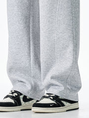 Men's grey casual loose-fit sweatpants with drawstring detail and visible stitching.