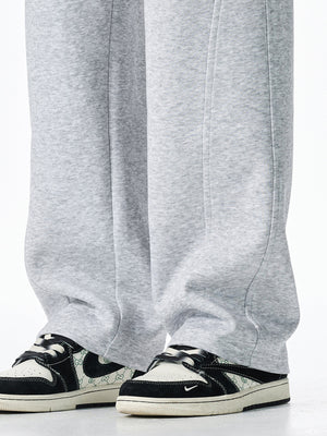 Men's grey casual loose-fit sweatpants with drawstring detail and visible stitching.
