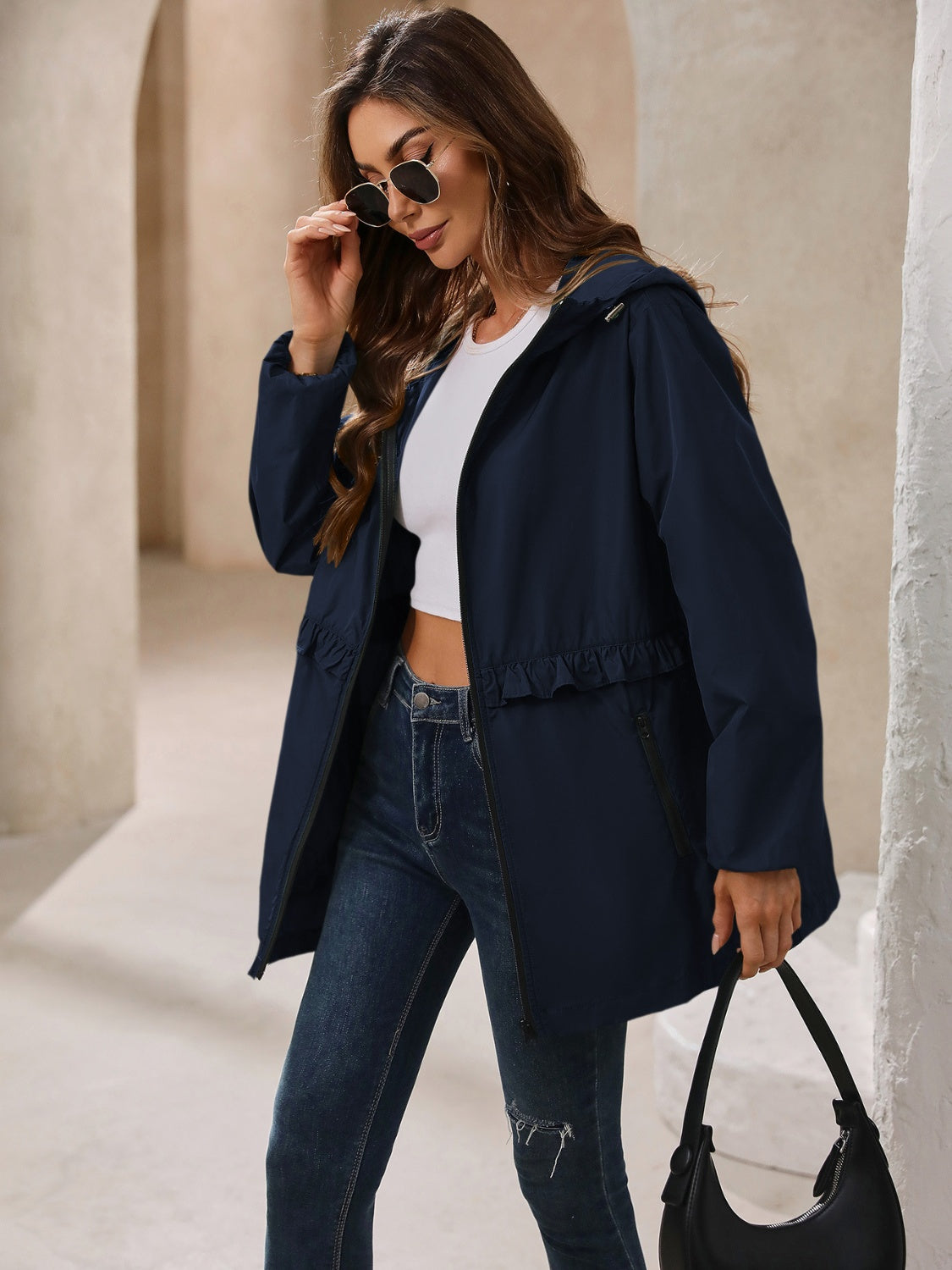 Navy hooded windbreaker jacket with ruffled waistline and zip pockets
