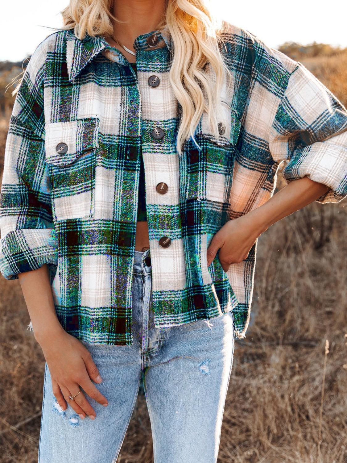 Plaid pocket long sleeve shirt jacket in dark green with button front and frayed hem.