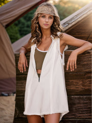 White sleeveless hooded romper with raw edges and zipper front, styled with a tank top.