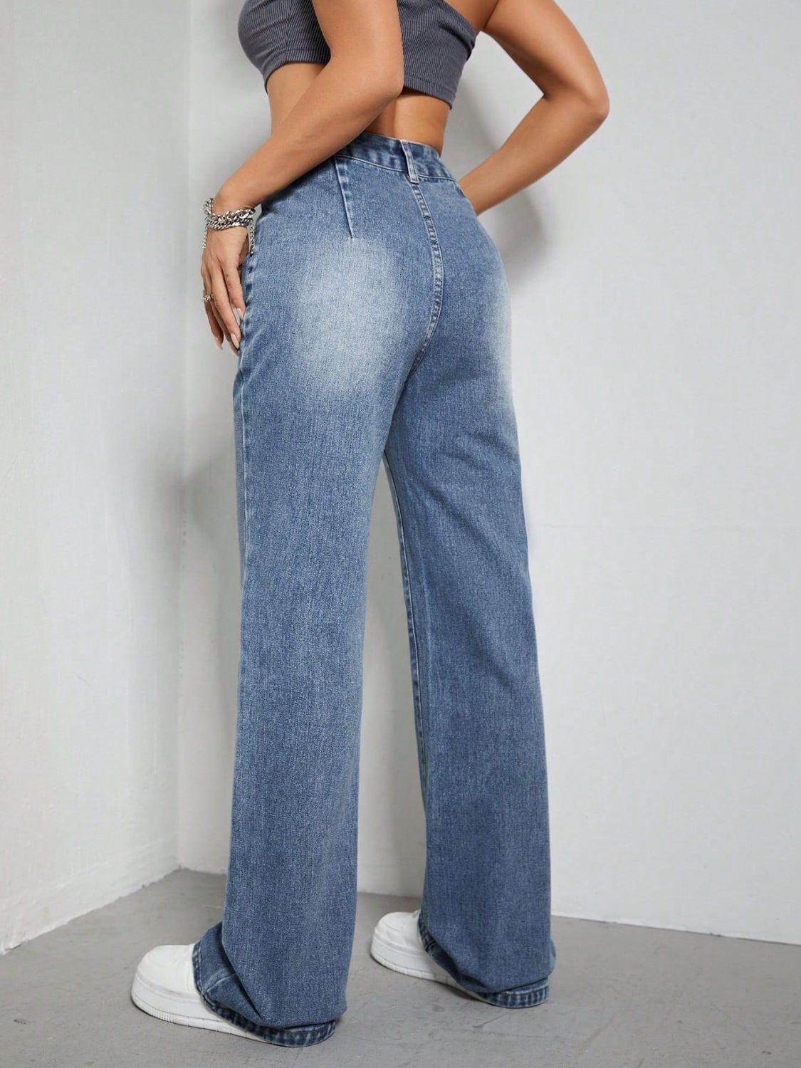 Medium wash denim wide-leg jeans with a relaxed fit and utility pockets.
