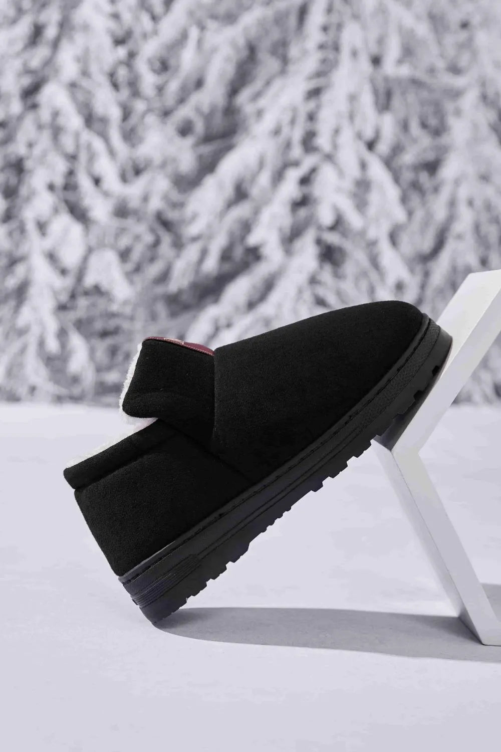Black suede shearling-lined house booties with a thick sole.