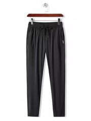 Men's black drawstring active pants with side logo detail.