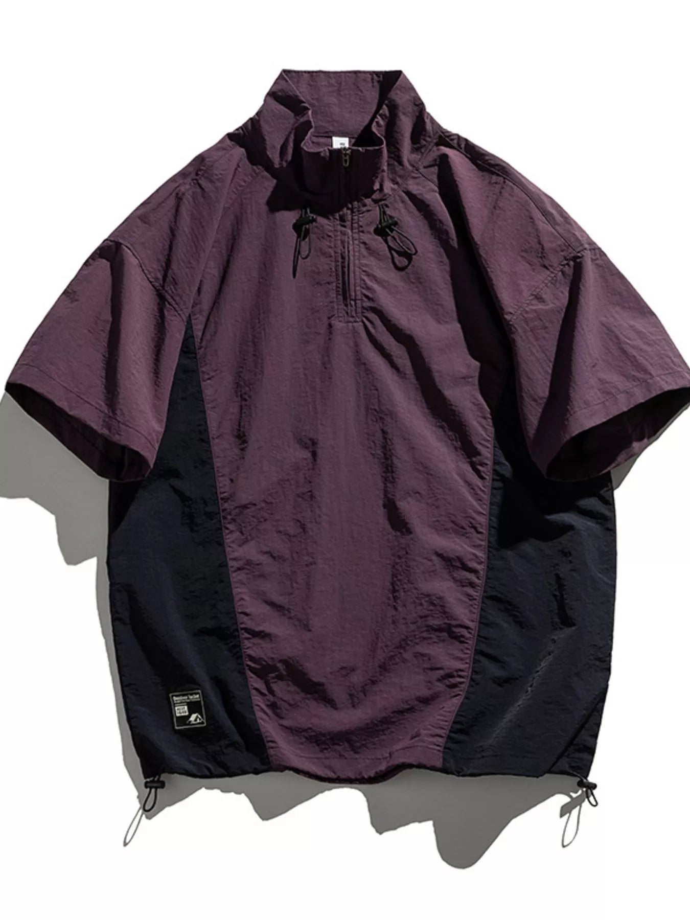 Violet and black lightweight pullover activewear top with short sleeves and quarter zip.