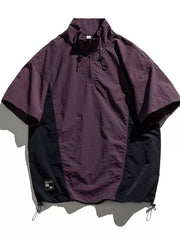 Violet and black lightweight pullover activewear top with short sleeves and quarter zip.