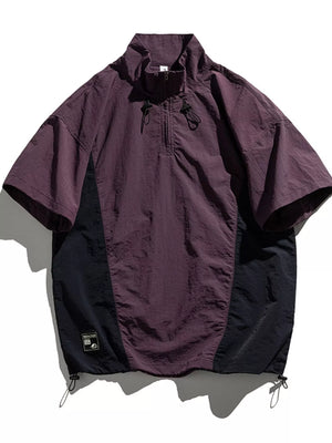Violet and black lightweight pullover activewear top with short sleeves and quarter zip.