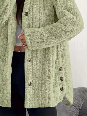 Green button-up fleece jacket with textured fabric and dark buttons.