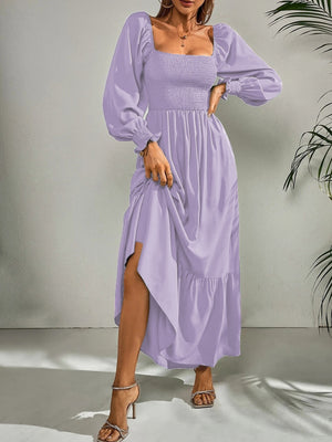 Purple midi dress with smocked bodice, square neck, puff sleeves, and tiered hem.
