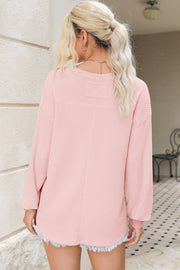 Blush pink waffle knit blouson sleeve top with crew neck and dropped shoulders.