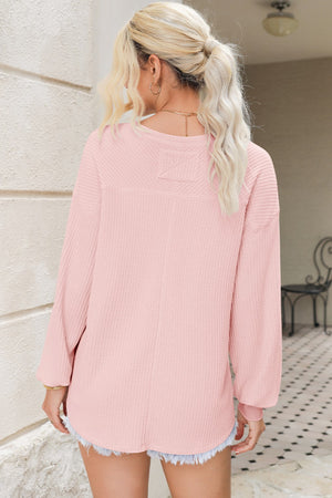 Blush pink waffle knit blouson sleeve top with crew neck and dropped shoulders.