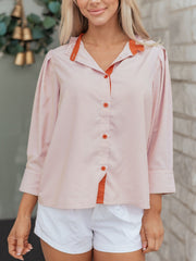 Pink striped maternity shirt with orange collar and buttons, button-down style.