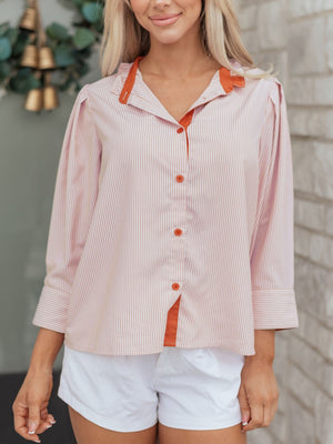 Pink striped maternity shirt with orange collar and buttons, button-down style.