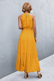 Yellow polka dot halter maxi dress with tiered skirt and tie waist