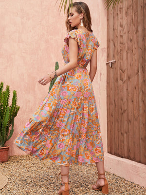 Bohemian floral tiered midi dress with flutter sleeves and a multicolor print.