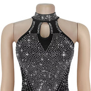Black halter neck romper with rhinestone embellishments and keyhole cutout.