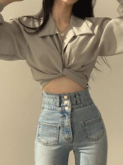 Grey polyester long sleeve shirt with twisted knot front detail and collar.