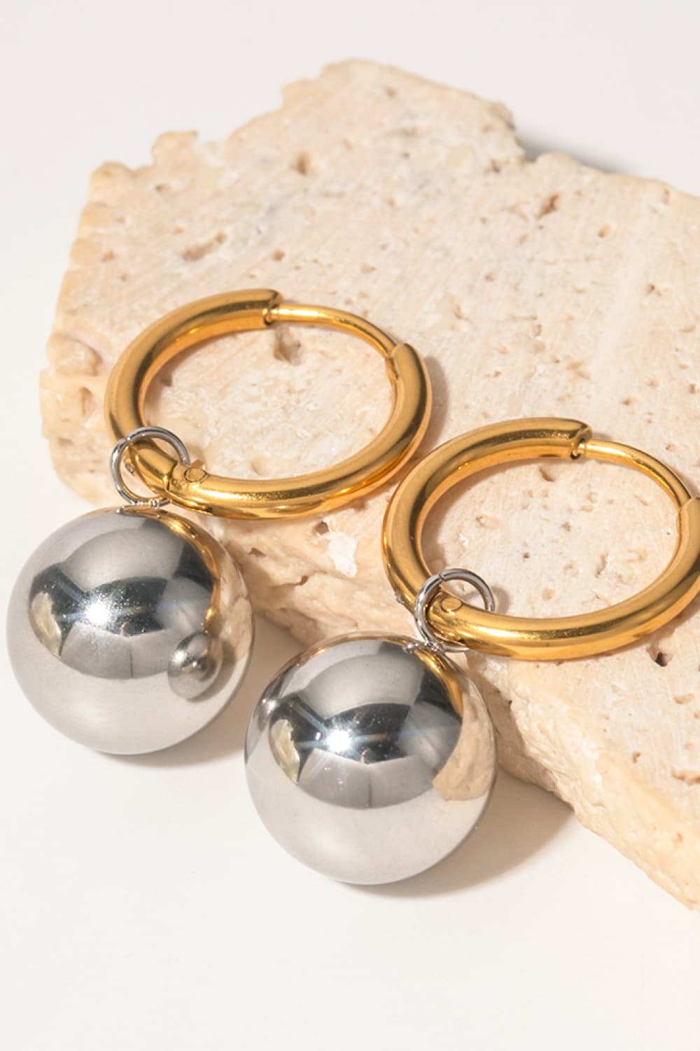 Gold hoop earrings with silver sphere drops