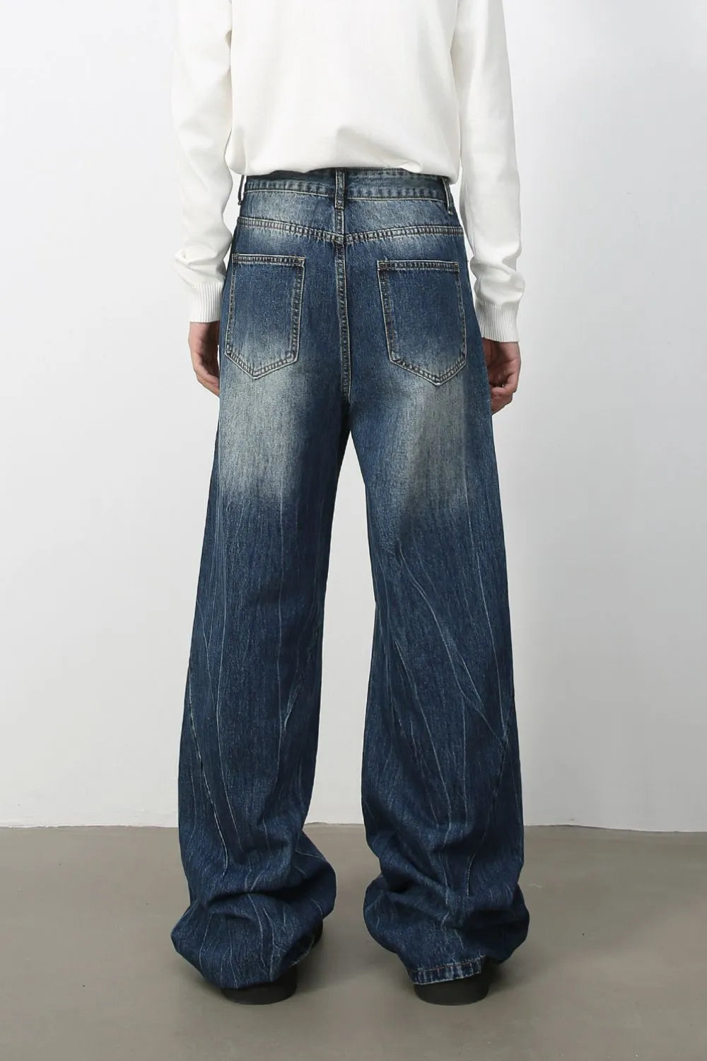 Oversized palazzo jeans in medium wash denim with a faded effect and vertical pinstripe texture.