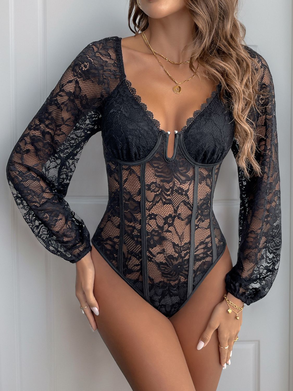 Black lace corset bodysuit with blouson sleeves and sweetheart neckline.