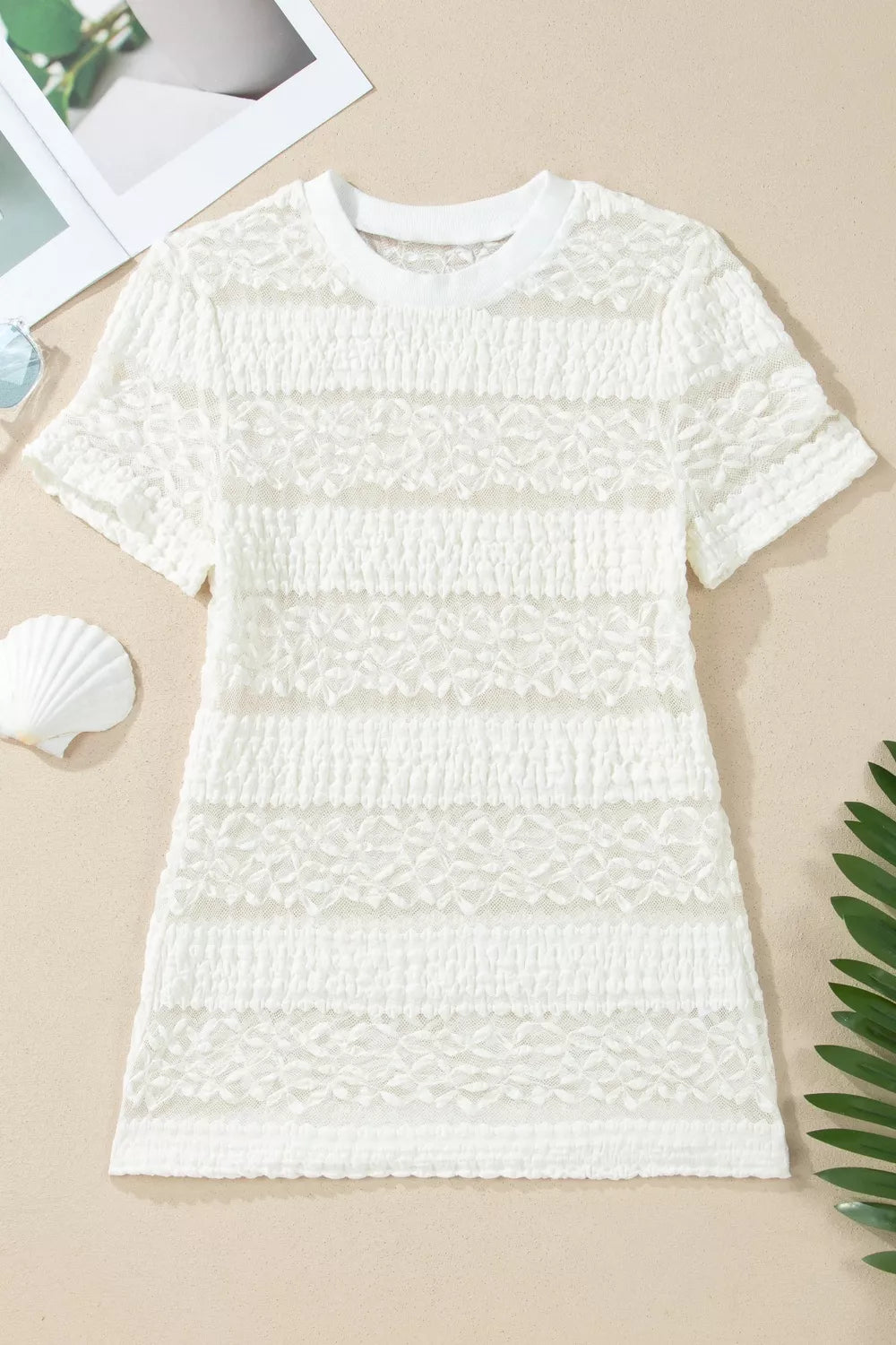 White sheer t-shirt with lace patchwork and textured stripes.