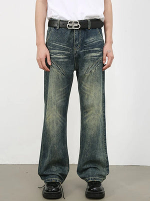 Vintage wash flare leg jeans in medium blue denim with whiskering and panel details.