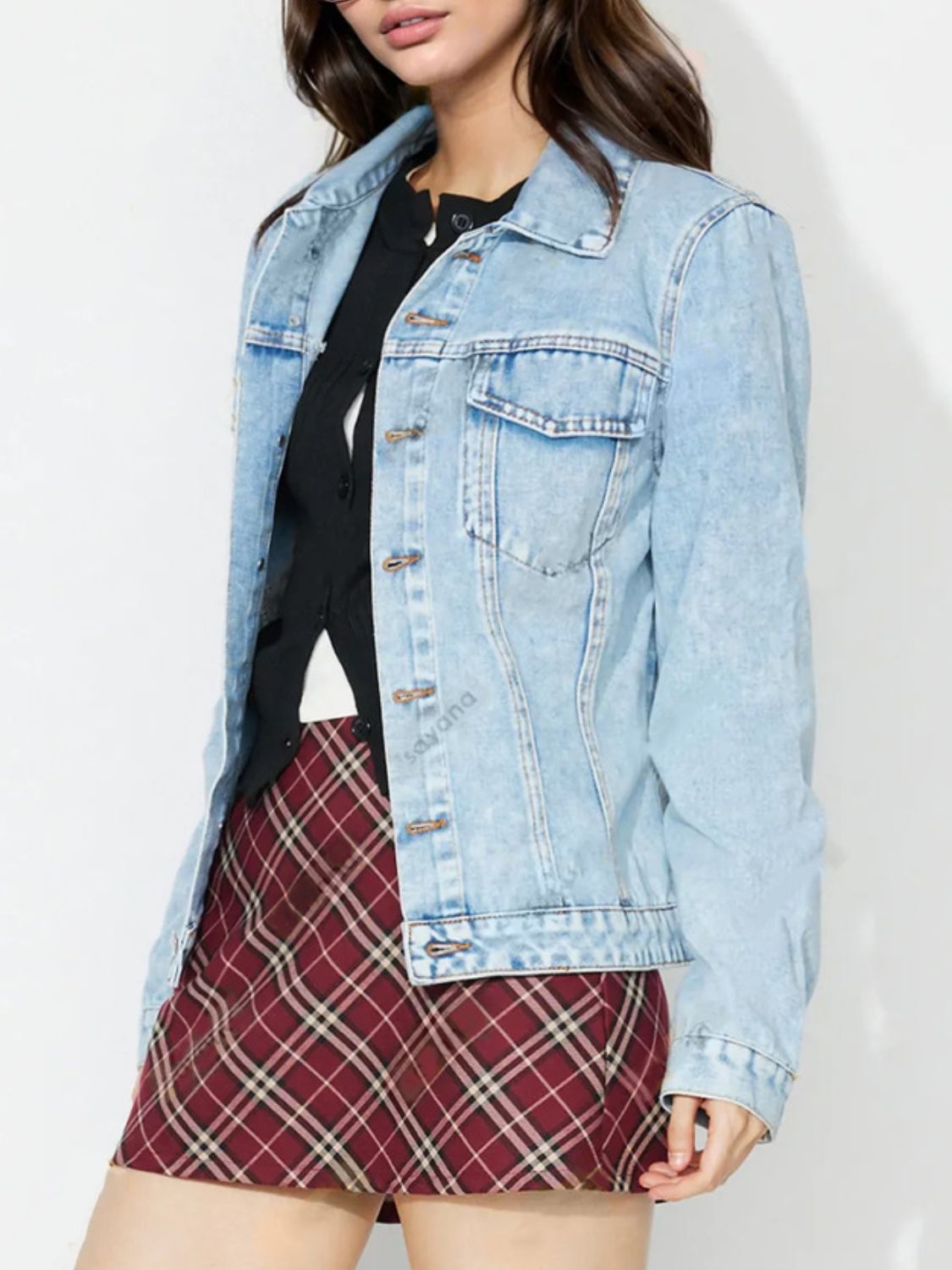 Light wash denim jacket with classic button details and chest pockets.