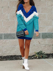 Turquoise V-neck knit dress with fringe detail and colorblock sleeves.